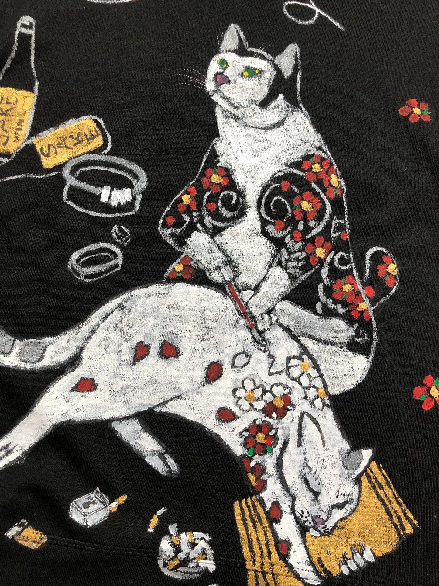 Women's long sleeve black T-shirt with a handmade cat pattern in detail