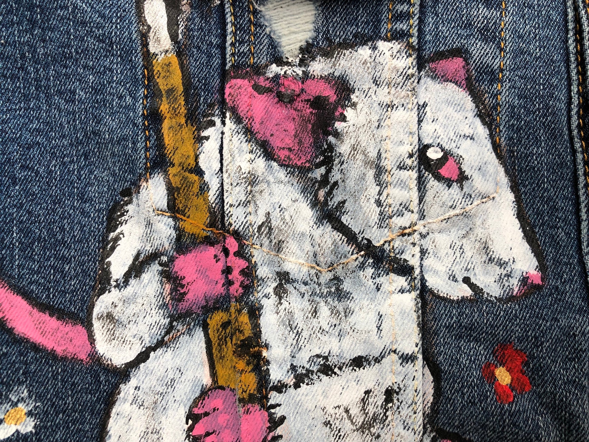 Detailed mouse with a scythe on a women's denim jacket