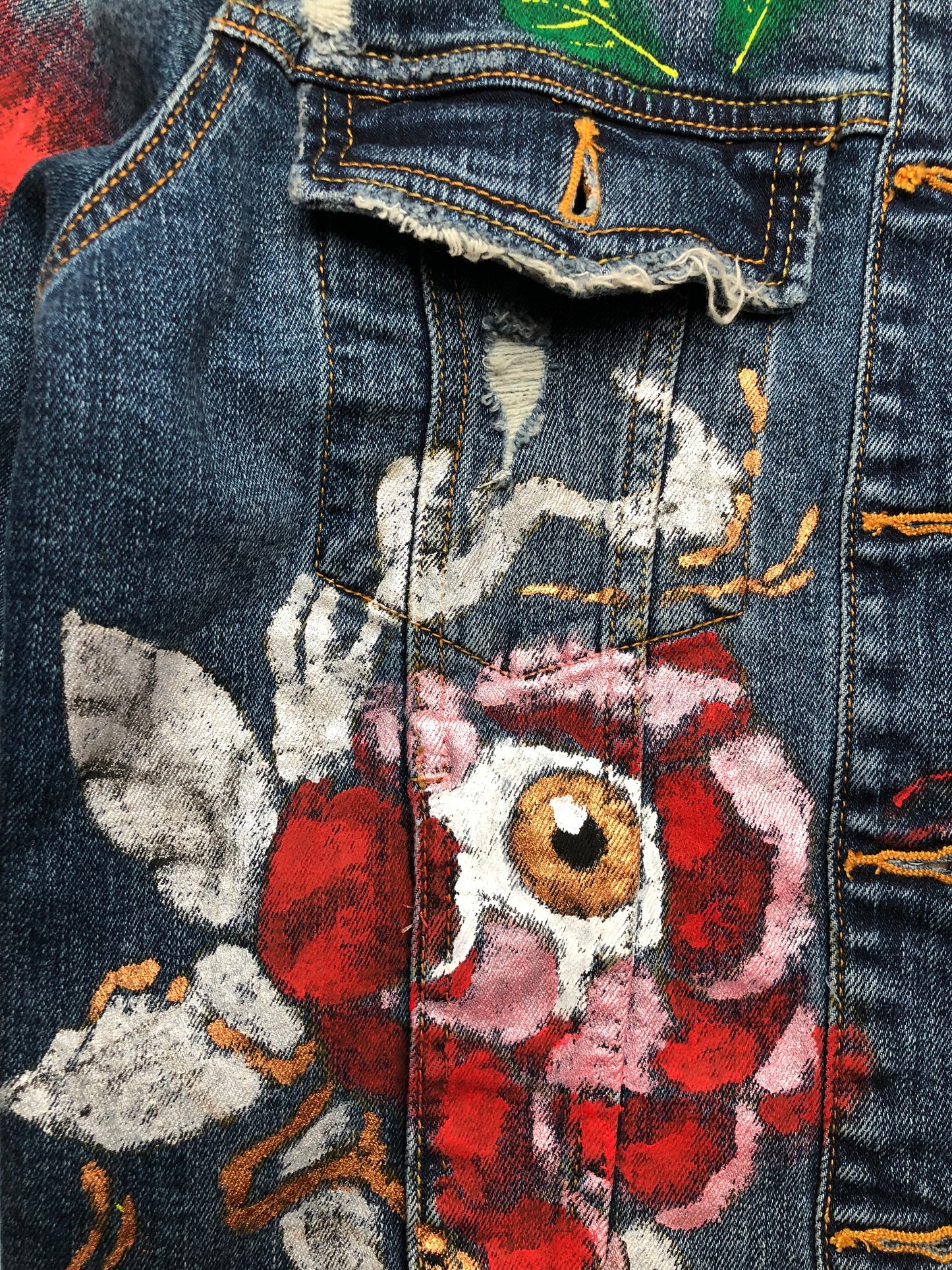 Very detailed flower-eye painting on a women's denim jacket