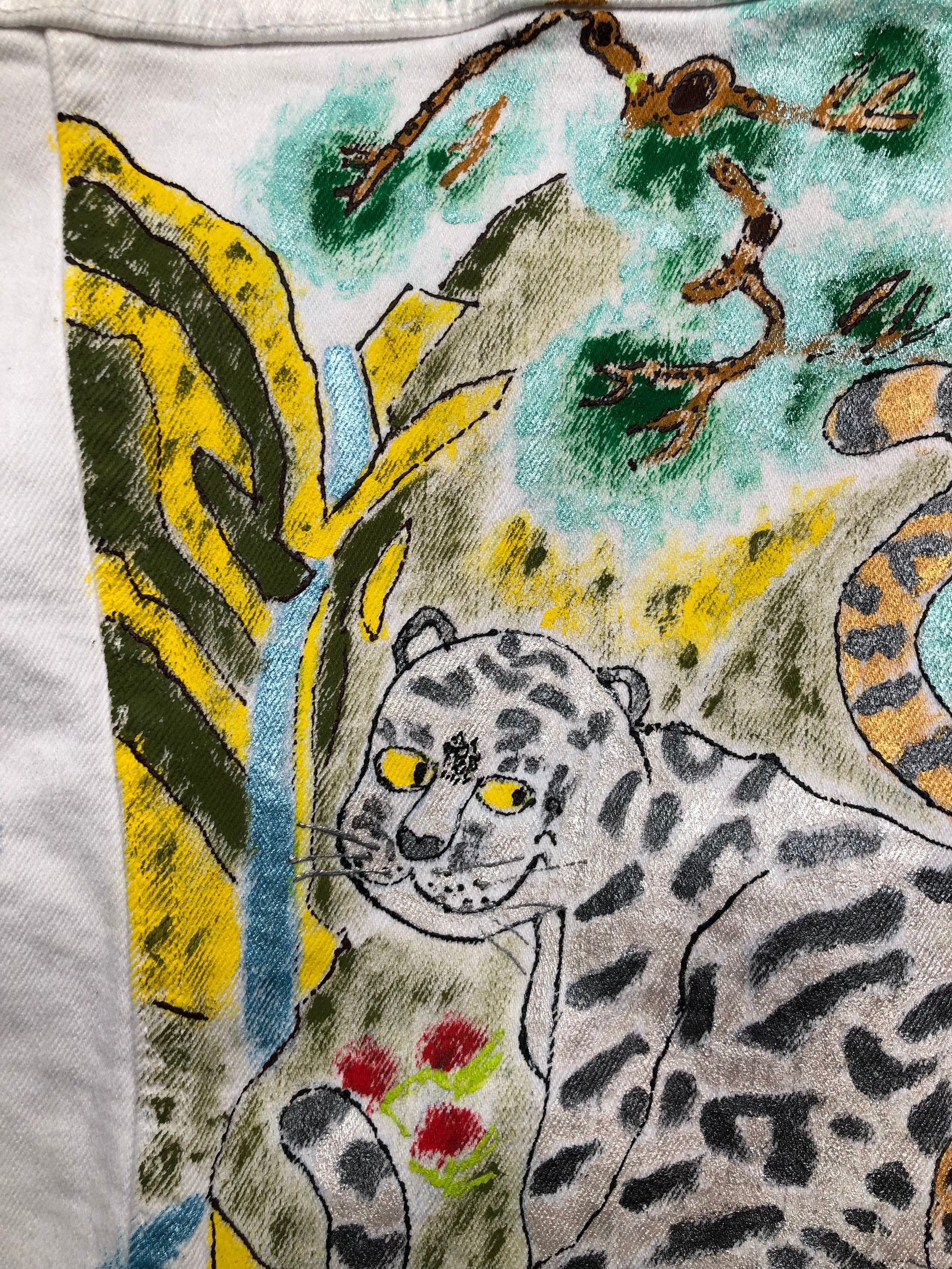 Cute tigress and waterfall on a denim jacket