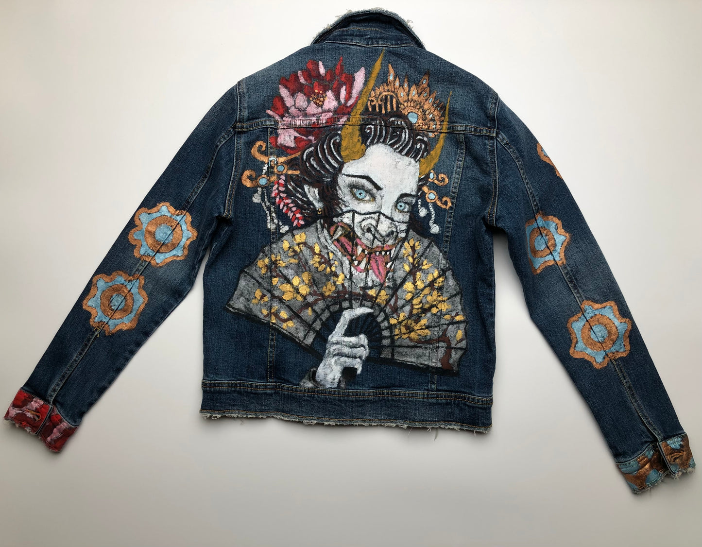 Painted demon on the back of a women's denim jacket