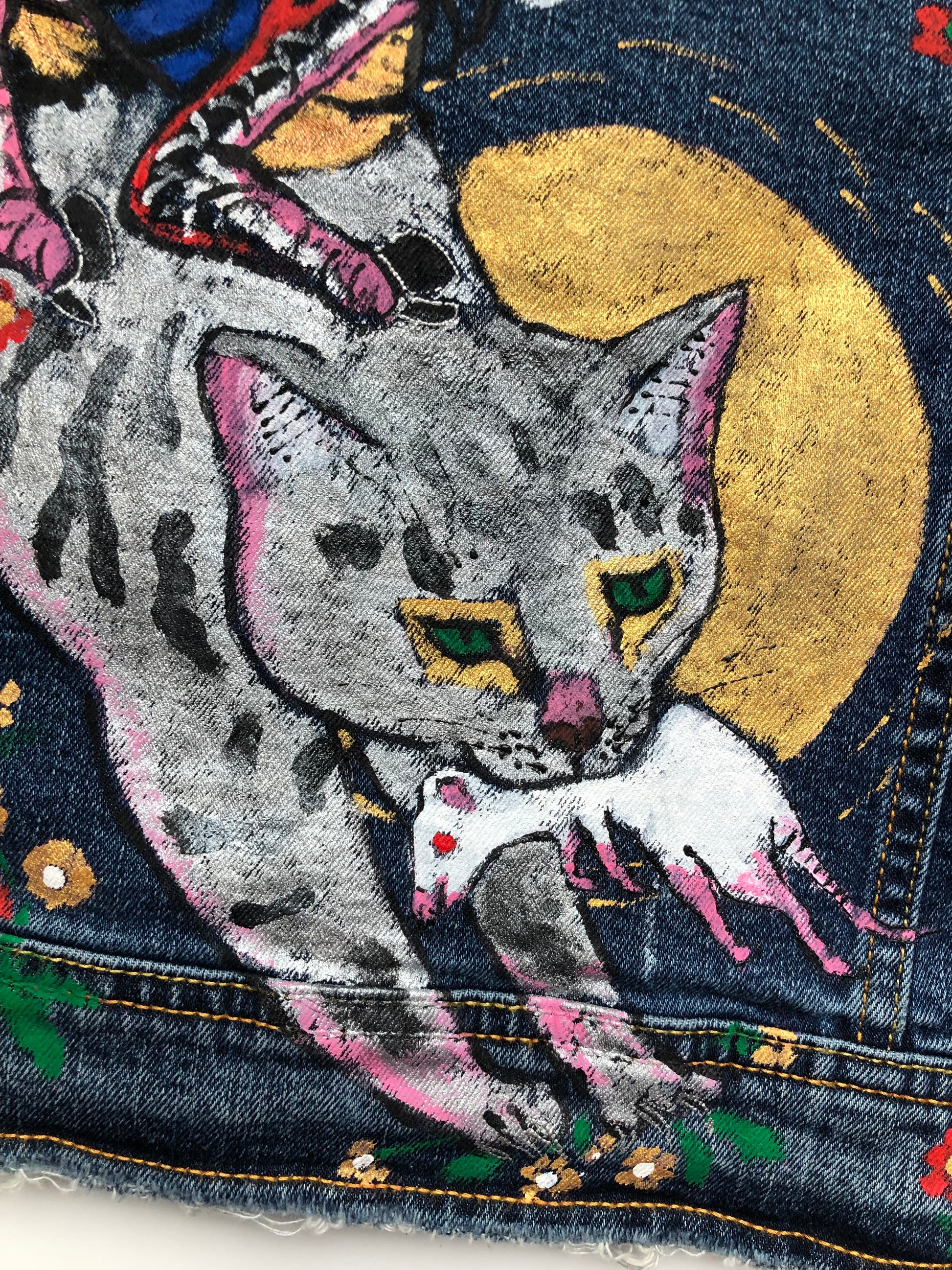 Datatally a cat with a mouse on the back of a women's denim jacket