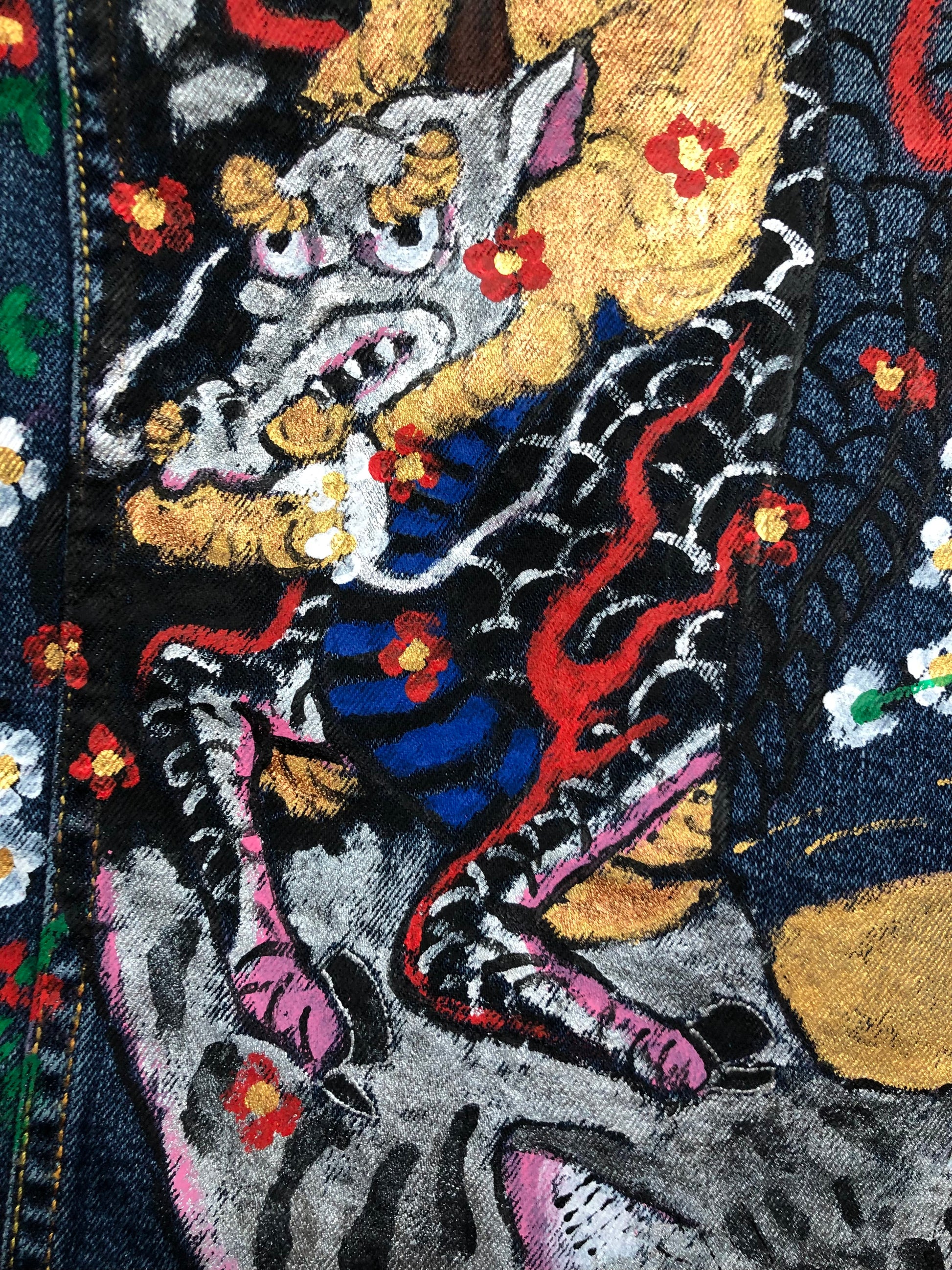 Demon tattoo with hooves on a women's denim jacket