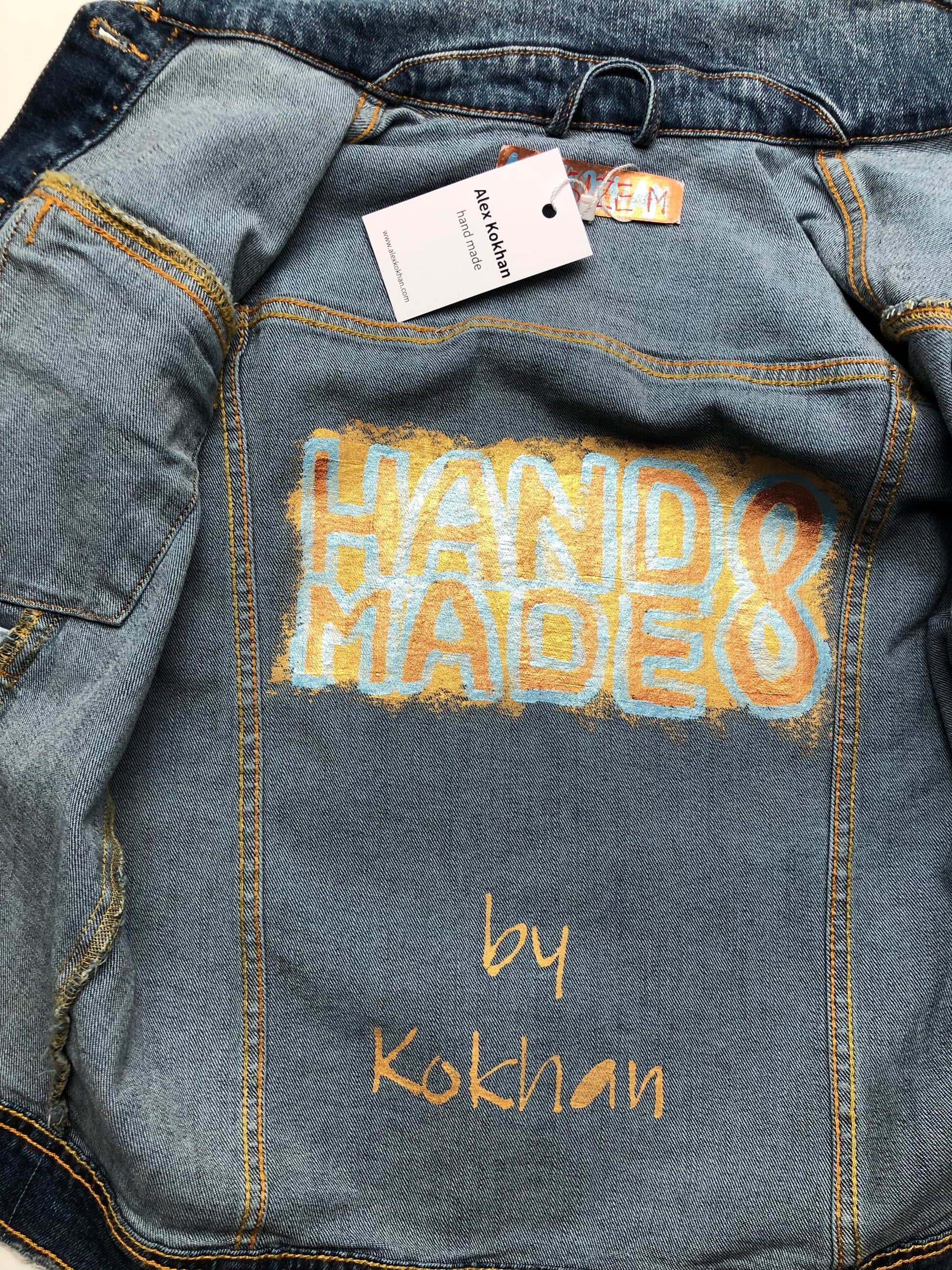 Painting on the inside of a women's denim jacket with a demon