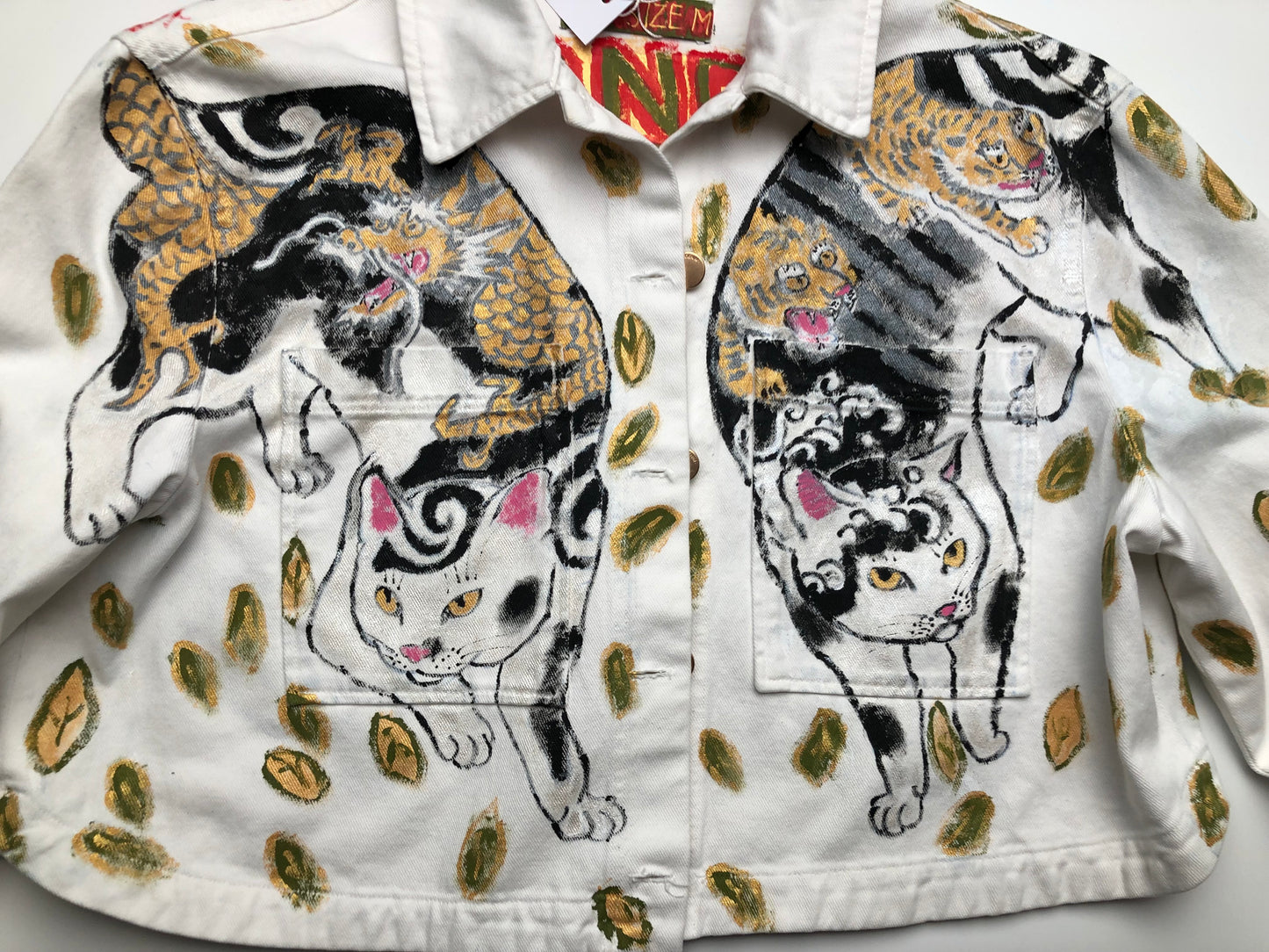 Cats in detail on a white women's denim jacket