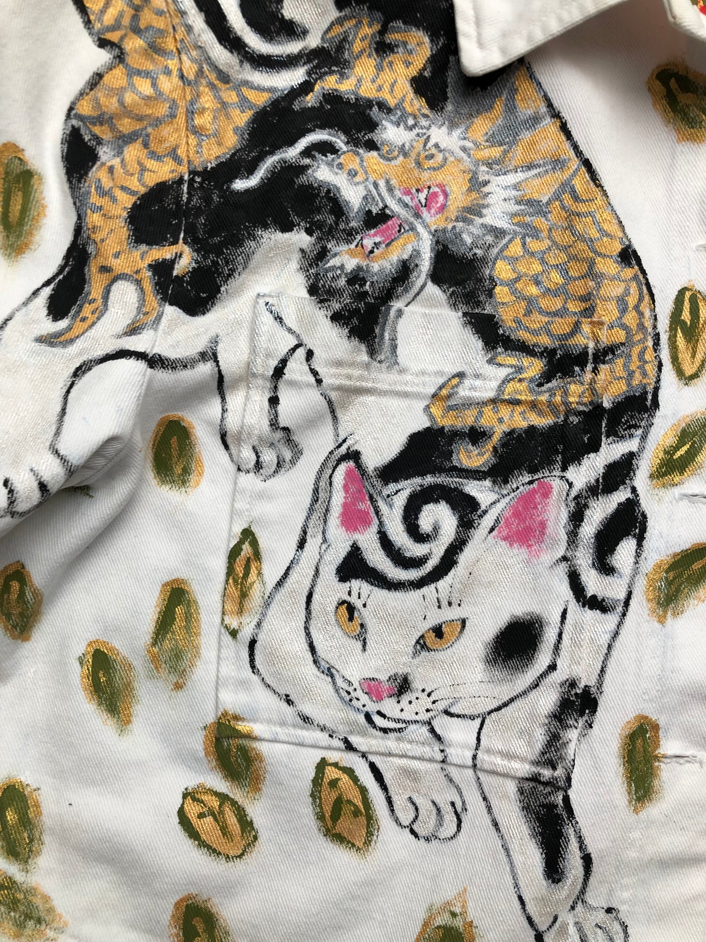 Cute cat with a mustache and an evil dragon tattoo on a women's denim jacket