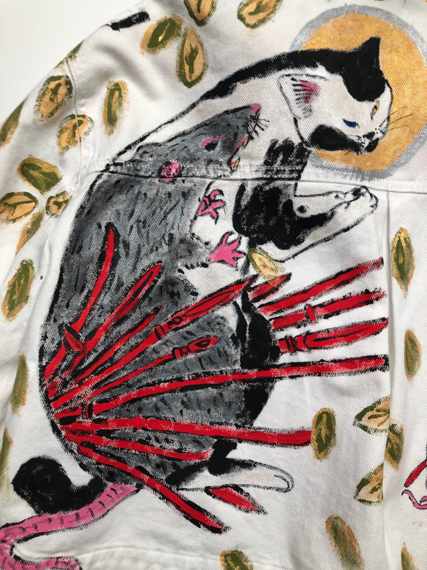 Praying cat with a rat in detail on a women's denim jacket