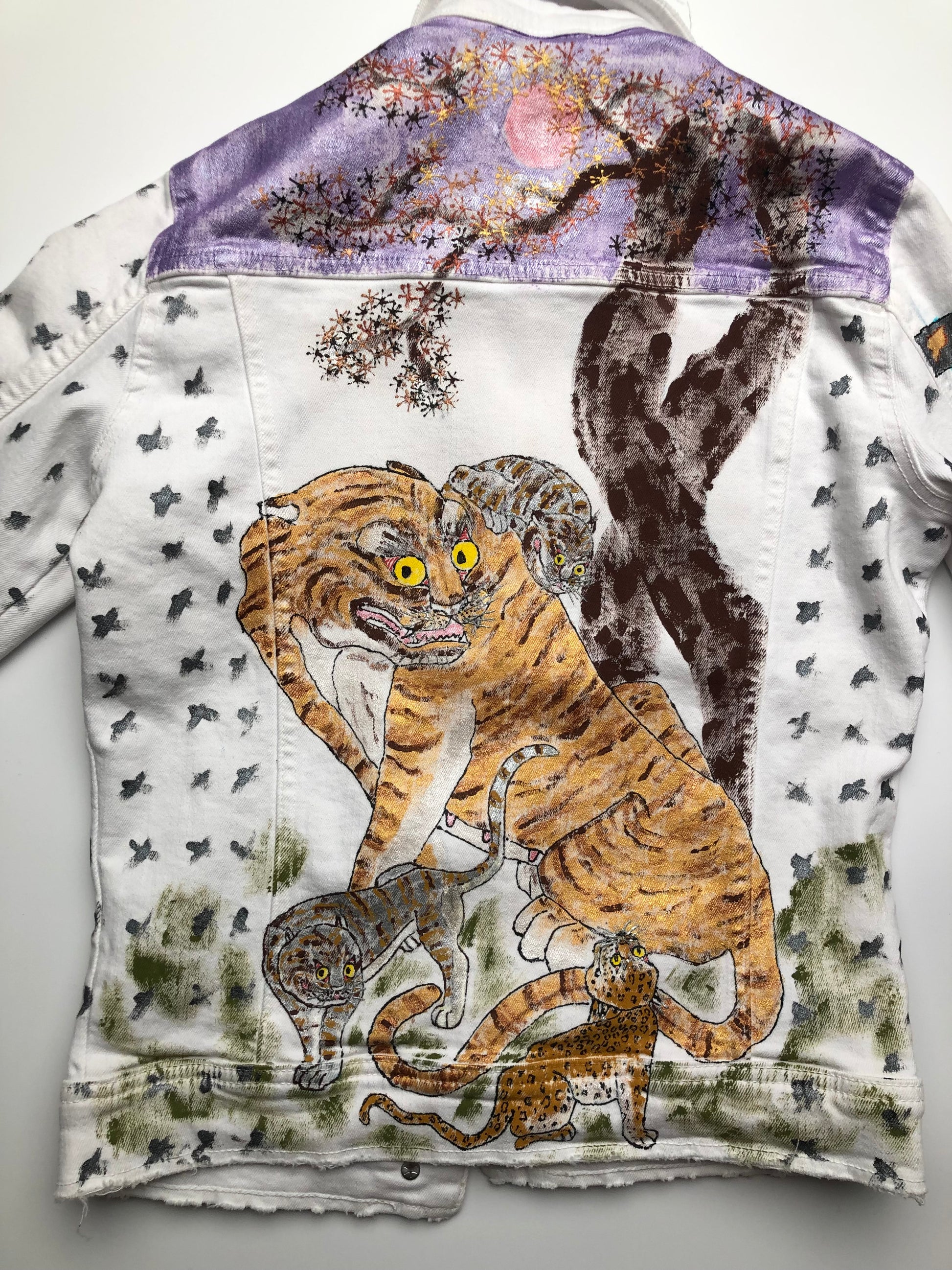 Women's white denim jacket with painted tigers on the back