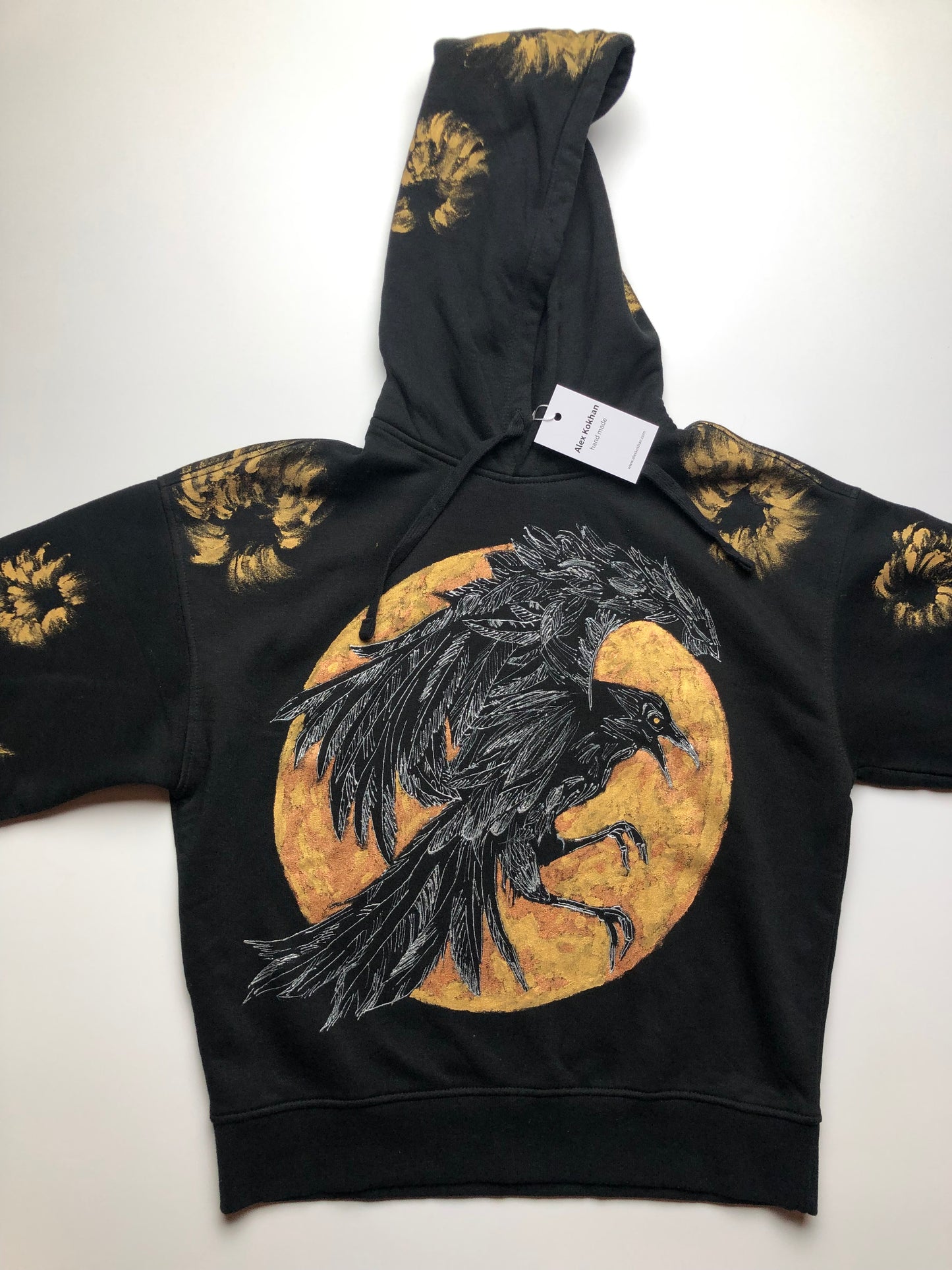 Women's black hoodie with a pattern of a golden raven