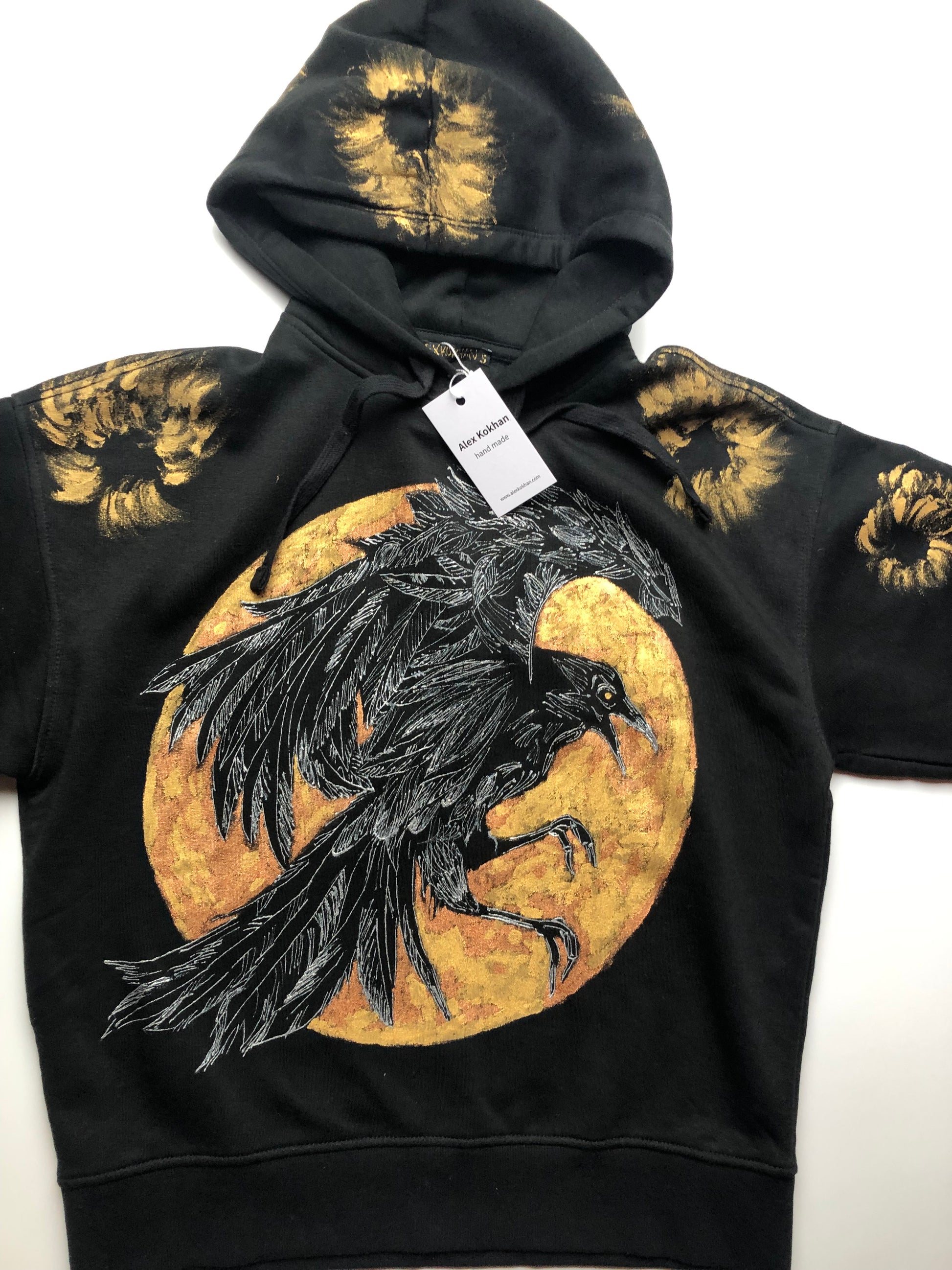 Women's black hoodie with golden raven pattern details