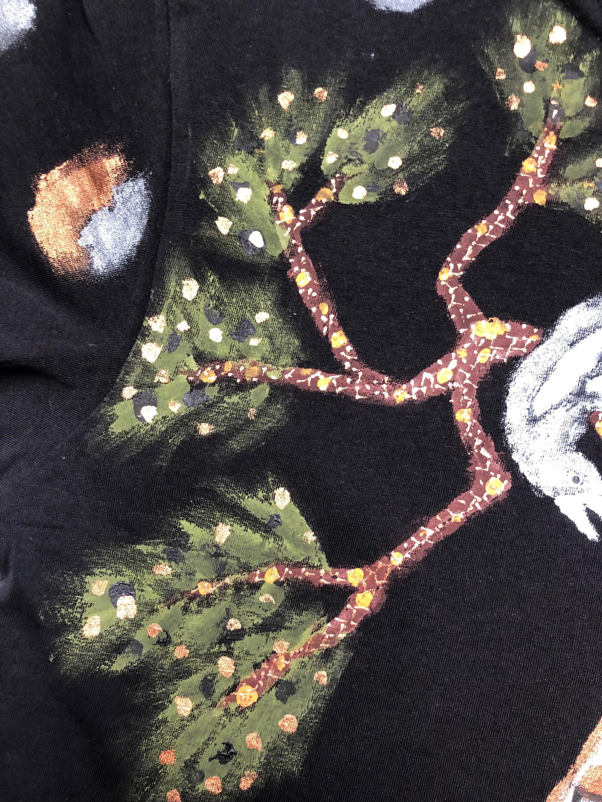 Details of an exquisite branch design with foliage on a t-shirt