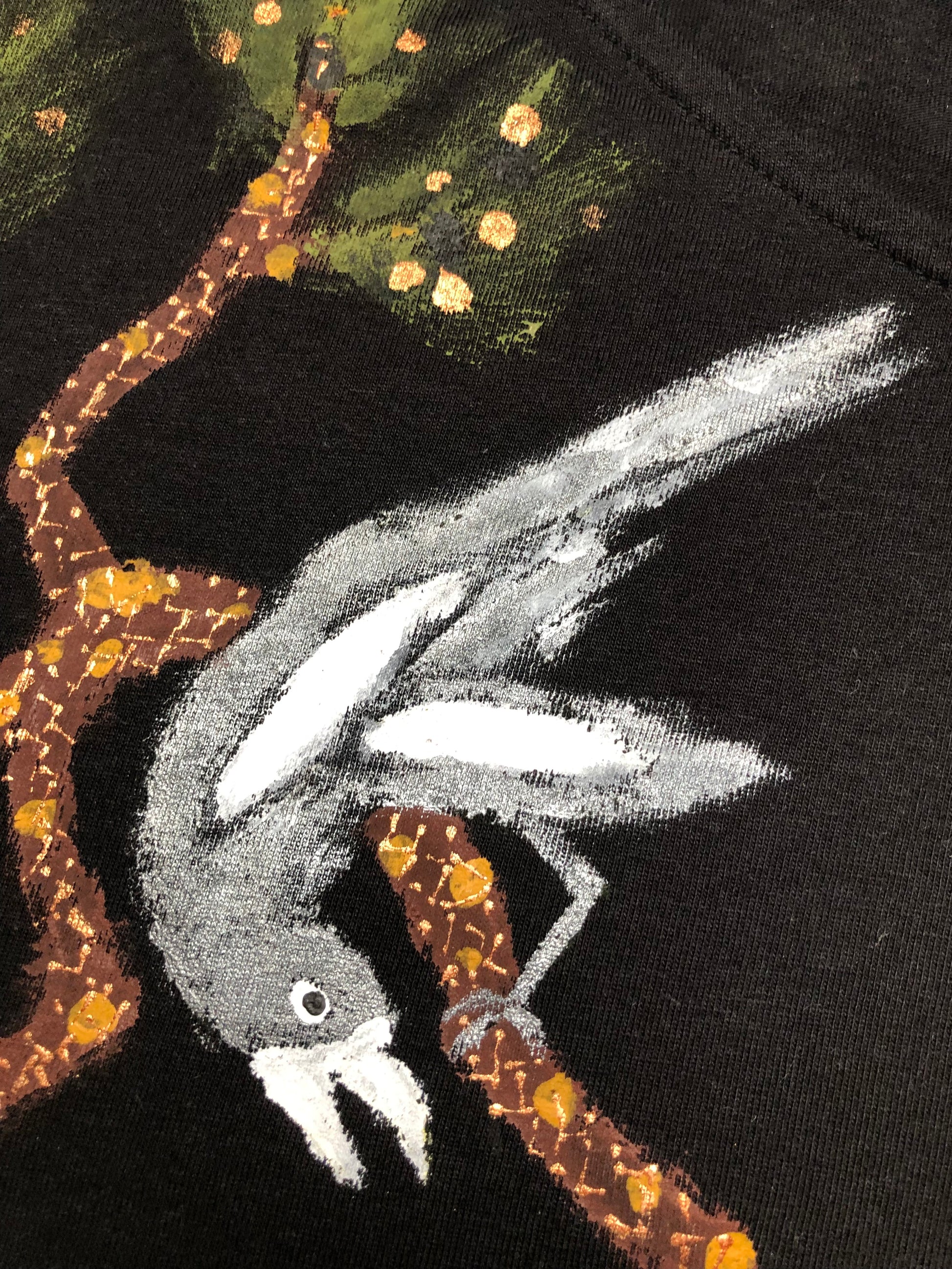 Detail of a bird on a branch on a T-shirt