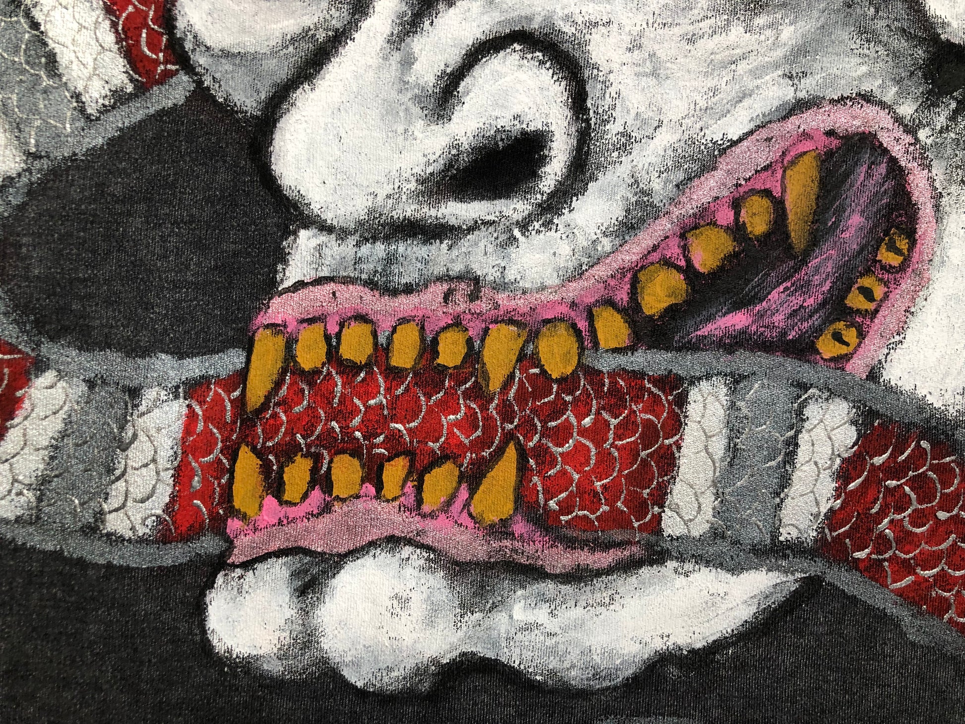 Detailed mouth of a demon with fangs and a snake on a women's t-shirt